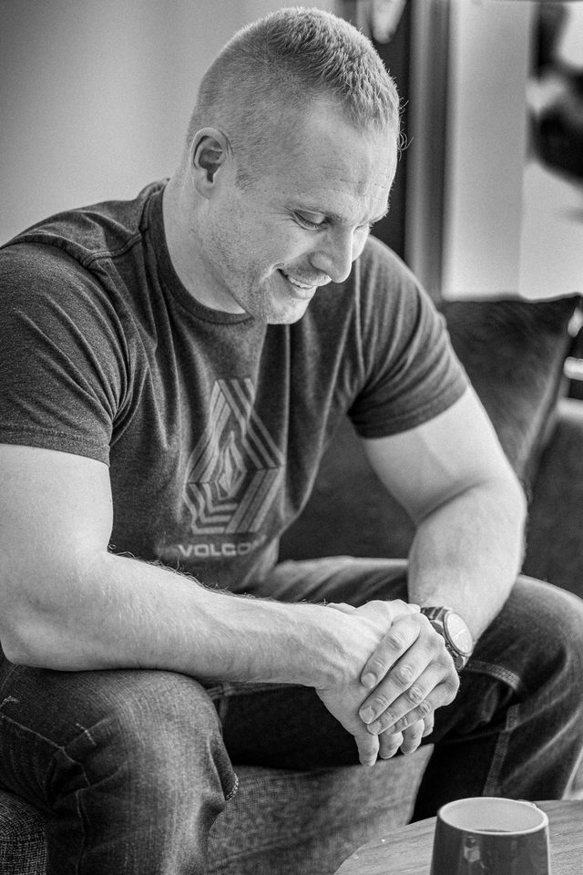 Dating profile photo example: client laughing over coffee, black and white natural light portrait